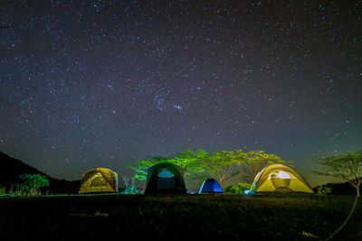 Tent on field against sky at night