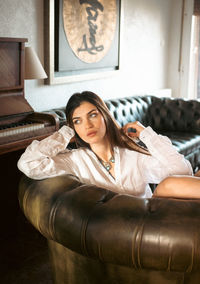 Portrait of young woman sitting at home