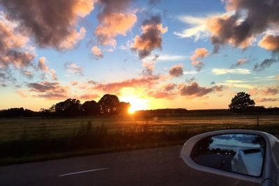 Car on road against sky during sunset