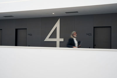 Mature businessman running at hotel corridor