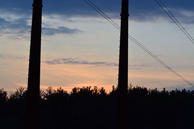 Silhouette of trees against sky at sunset