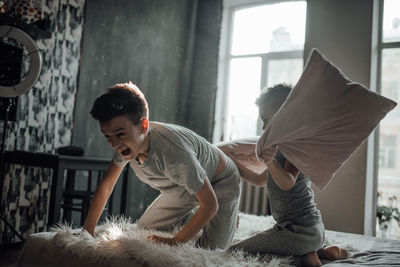 Young man relaxing on bed at home