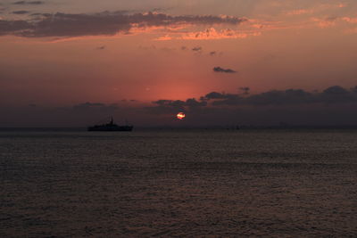 Scenic view of sea against orange sky
