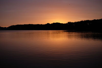 Scenic view of lake against romantic sky at sunset