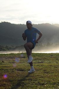 Man jogging against mountain range