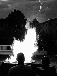 Woman standing on illuminated tree