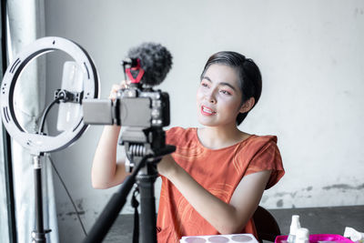 Portrait of smiling young woman looking away