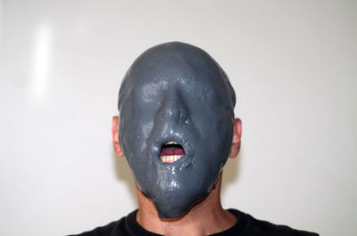Man wearing mask against white background