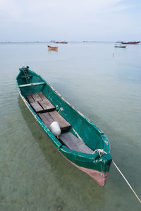 High angle view of boats moored on sea against sky