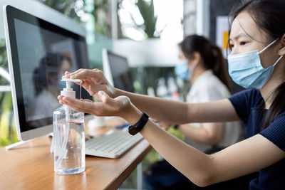 Woman using mobile phone on table