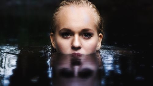 Portrait of beautiful woman swimming in lake