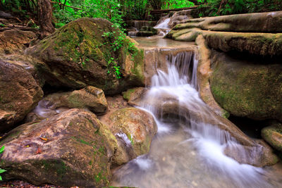 Stream flowing through rocks in forest