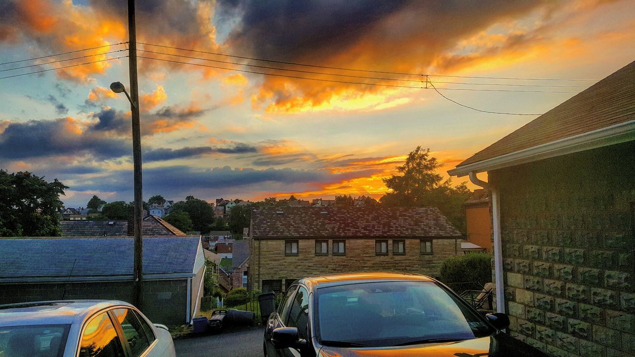 sunset, sky, orange color, cloud - sky, mode of transport, built structure, street light, power line, yellow, cloud, cloudy, cable, outdoors, no people, nature, dramatic sky, parking, weather, beauty in nature, power supply