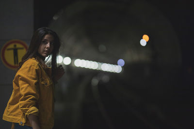 Close-up of young woman against wall