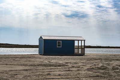 Scenic view of beach shack against sky