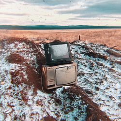 Close-up of old telephone booth against sky