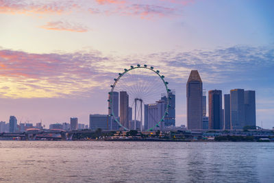 Singapore ferris wheel and business district and city, marina bay of singapore on february 2, 2020.