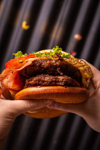 Close-up of hand holding burger