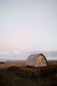 Built structure on field against sky