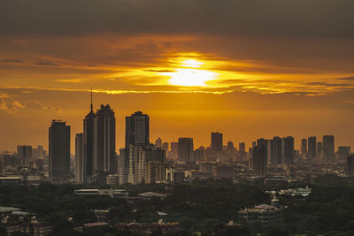 Scenic view of buildings against sky during sunset