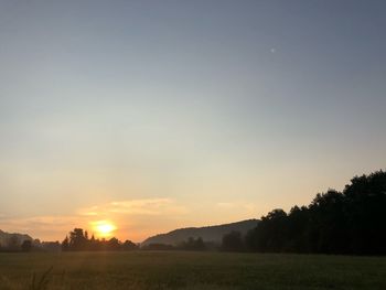 Scenic view of field against sky during sunset