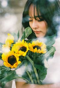 Portrait of woman with yellow flowers