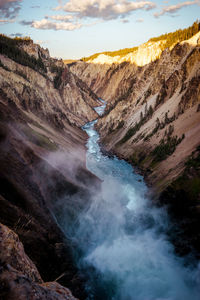 Scenic view of water amidst mountain against sky