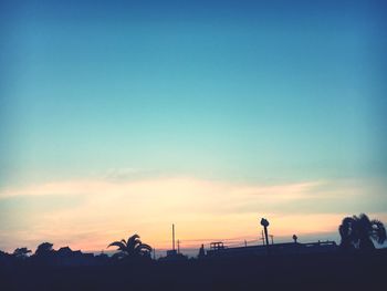 Silhouette of trees against sky at sunset