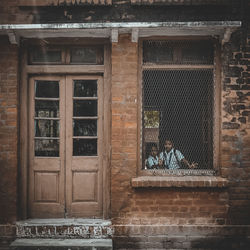 Siblings seen through window