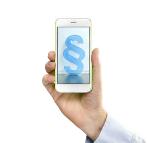 Close-up of hand holding smart phone over white background