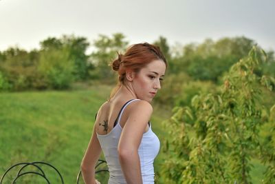 Woman standing on grassy field