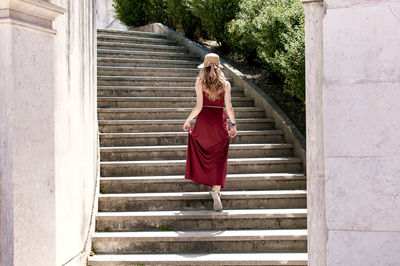 Rear view of woman walking on steps