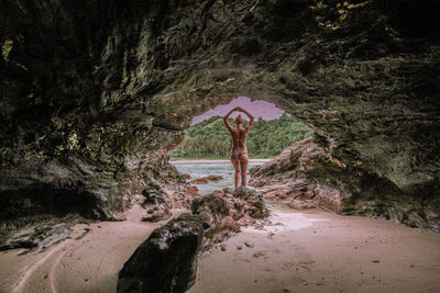 Man standing on rock in forest