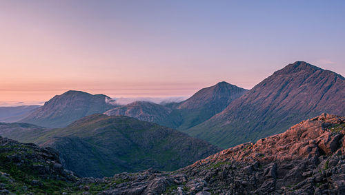 Evening sun setting on the tops of marsco and bla bheinn which are part of the red cuillin on skye