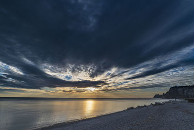 Scenic view of sea against dramatic sky