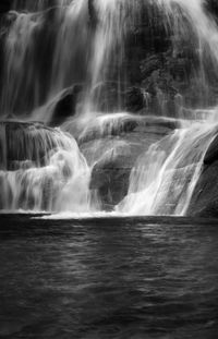 Scenic view of waterfall against sky