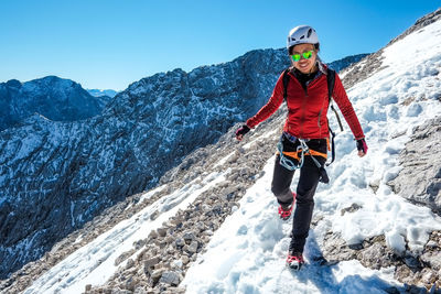 Portrait of man skiing on snow covered mountain