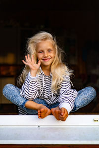 Portrait of smiling girl sitting outdoors