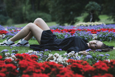Full length of young woman lying down on land