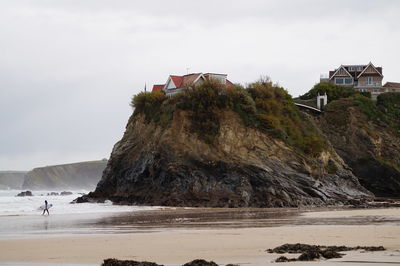 Houses on rock formations at beach
