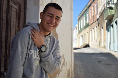 Portrait of a smiling young man standing outdoors