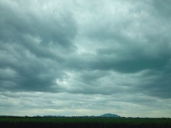 Scenic view of landscape against cloudy sky