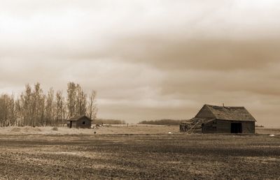 Barn on field against sky