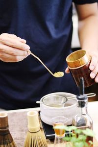 Midsection of man preparing food