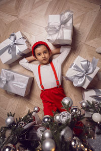 High angle view of girl playing with christmas decorations