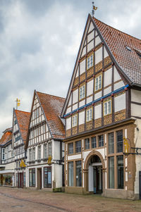 Building by street against sky