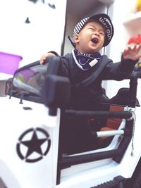 Close-up of a boy playing in a car