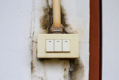 Close-up of electric lamp on wall