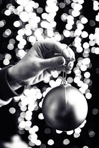 Cropped hand of woman holding light bulb