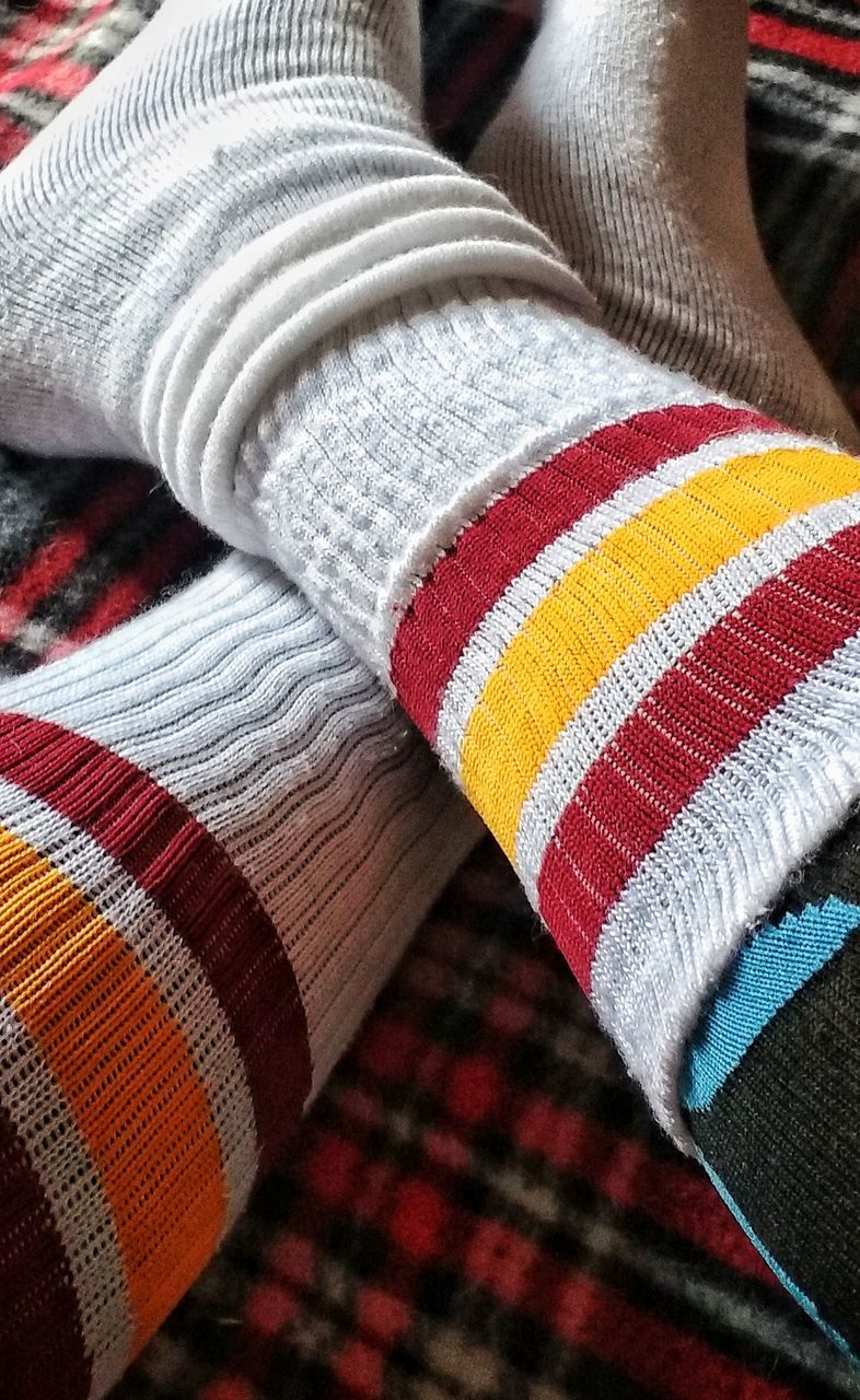 multi colored, textile, close-up, pattern, wool, no people, indoors, art and craft, striped, clothing, focus on foreground, high angle view, variation, still life, material, choice, full frame, blanket, winter, textured, warm clothing, sock